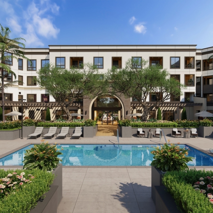 A welcoming courtyard features a serene pool surrounded by lush gardens, offering a peaceful retreat for residents.