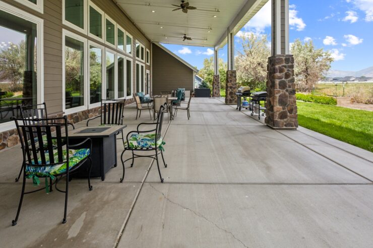 Spacious outdoor seating invites relaxation and community, surrounded by lush greenery and bright skies.