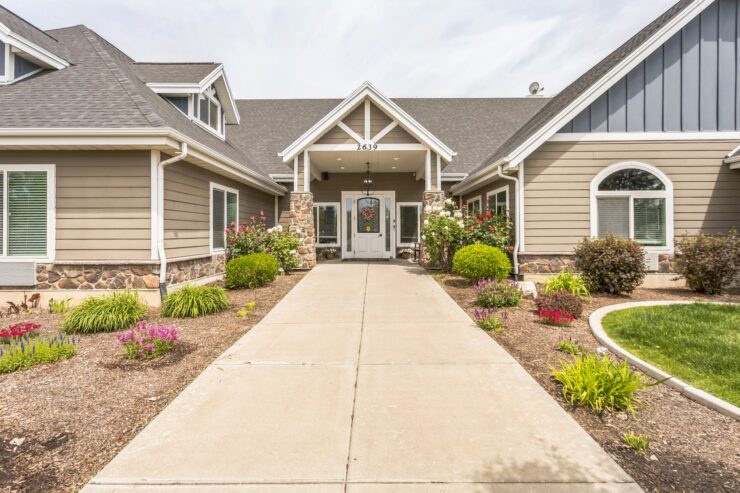 Welcoming entrance with vibrant gardens, inviting a sense of community and comfort.