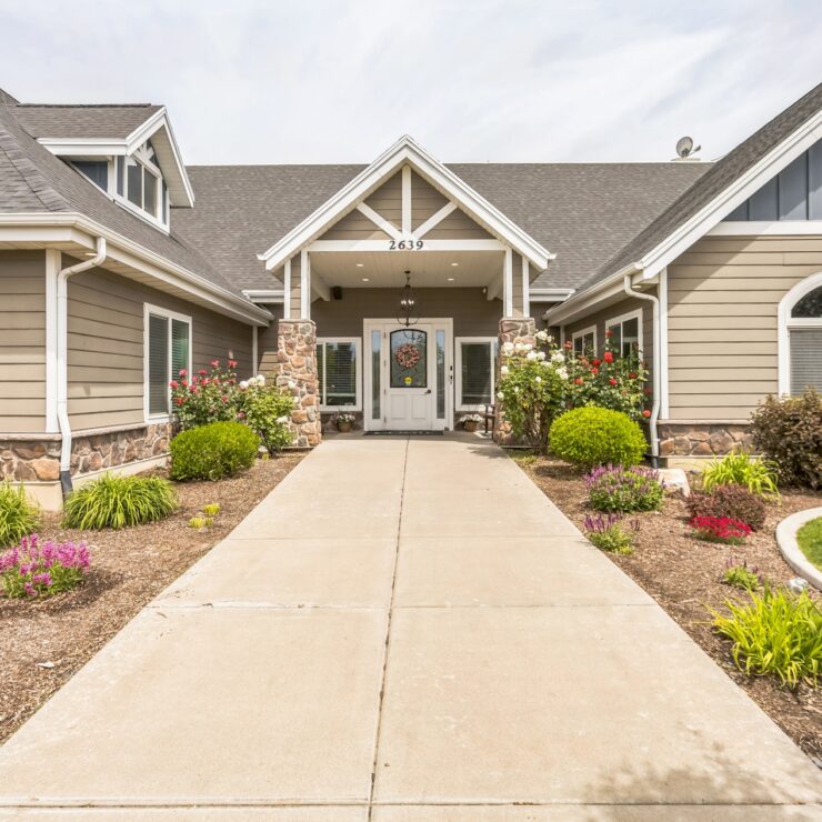 Welcoming entrance with vibrant gardens, inviting a sense of community and comfort.