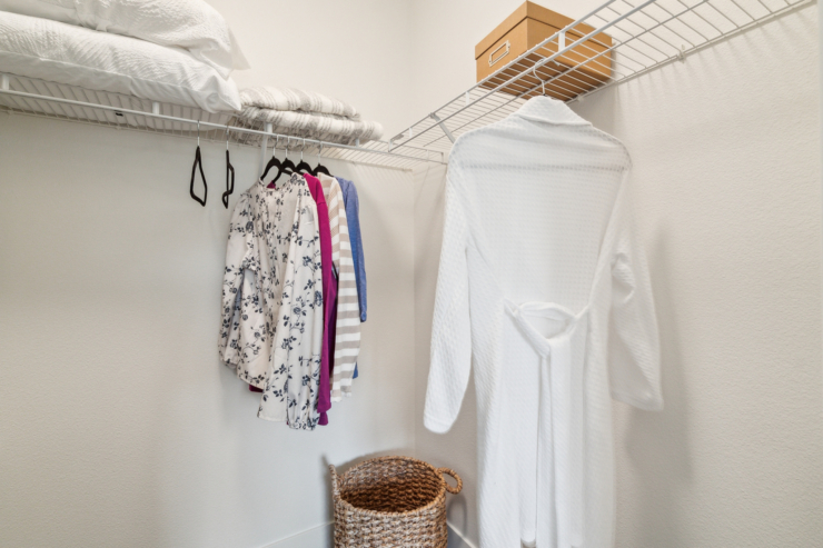 A bright, organized closet filled with cozy clothing and soft linens, creating a welcoming atmosphere.