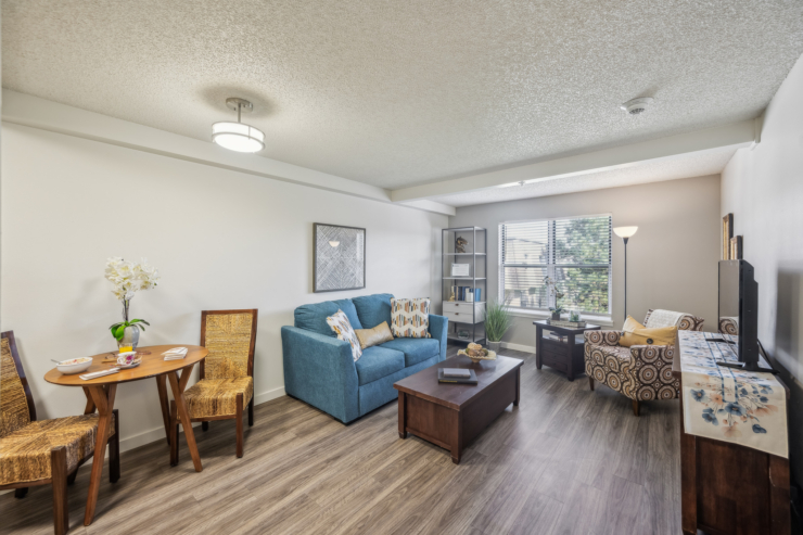 A bright, inviting living space with comfortable seating, perfect for community gatherings and relaxation.
