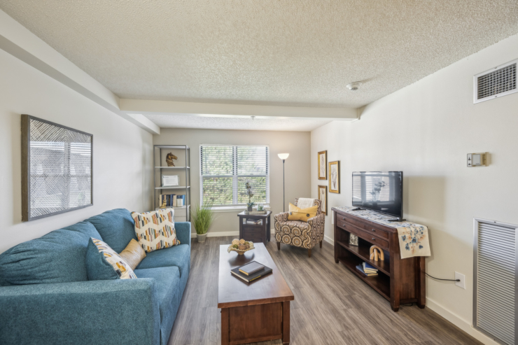 A cozy living space filled with natural light, inviting furniture, and warm decor, perfect for community gatherings.