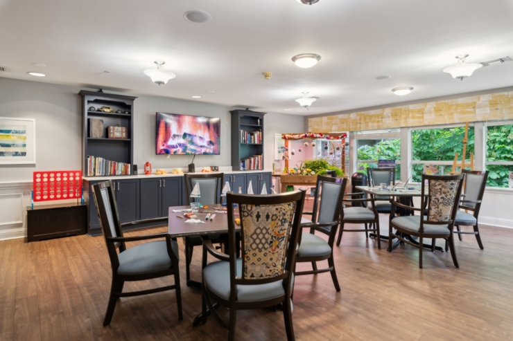 A welcoming community space filled with natural light, inviting seating, and engaging activities.