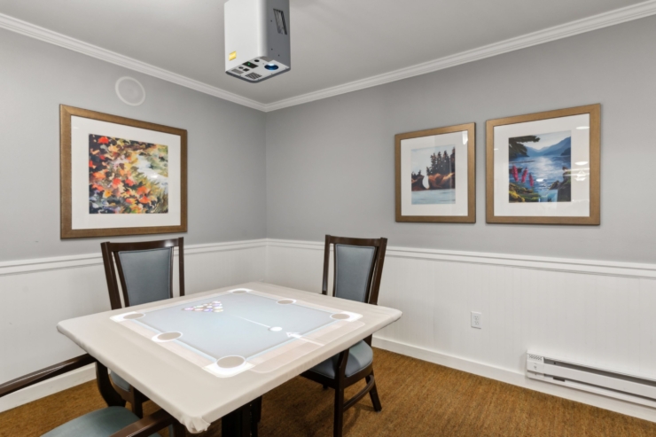 A welcoming activity room featuring comfortable seating, vibrant artwork, and an inviting atmosphere.