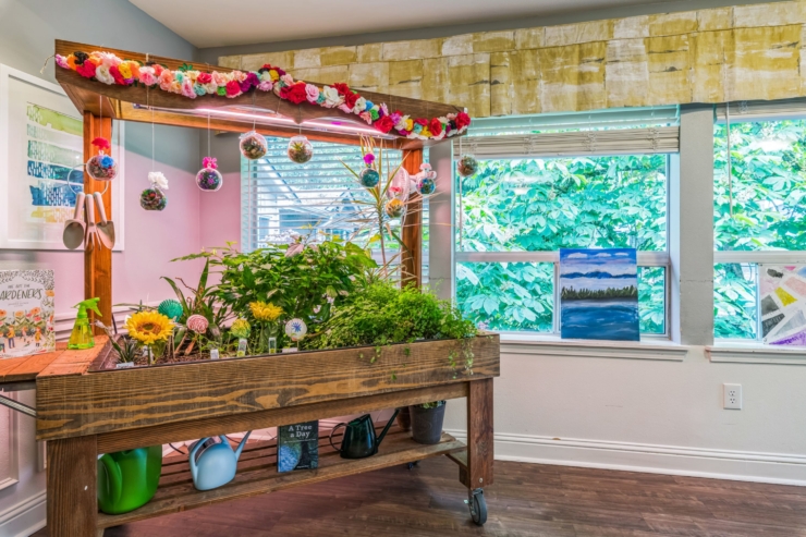 Bright, inviting garden corner filled with vibrant plants and cheerful decorations, fostering creativity and community.