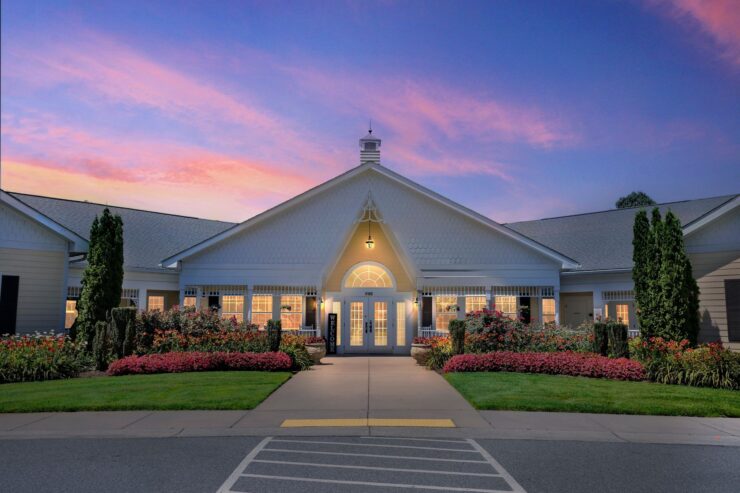 A welcoming entrance surrounded by vibrant gardens, inviting residents to a warm community atmosphere.