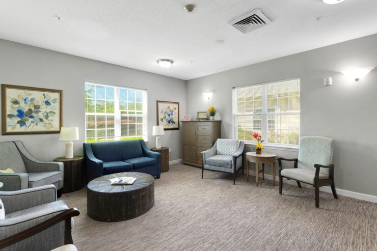 A welcoming lounge filled with natural light, comfortable seating, and vibrant decor invites community connection.