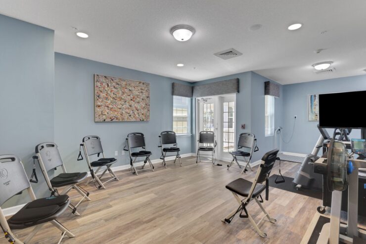A welcoming activity room with seating, natural light, and art, fostering community and comfort.