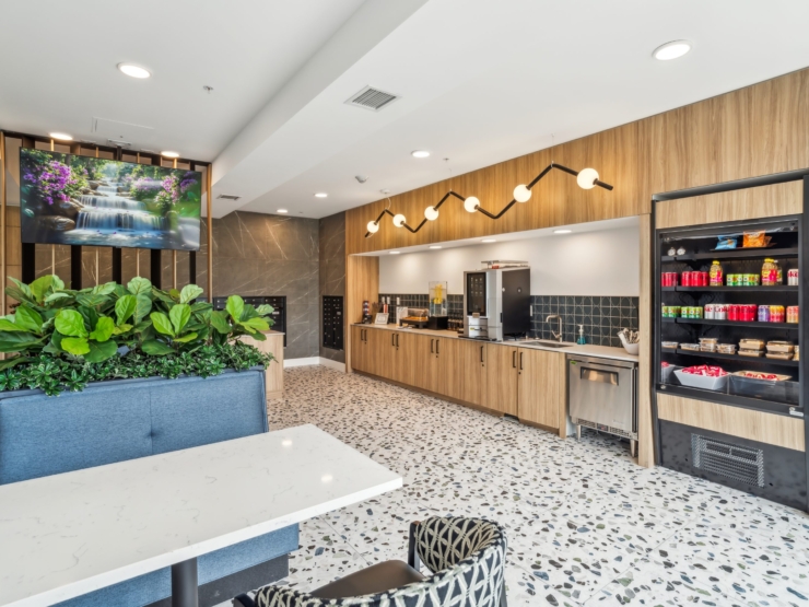 Bright, inviting space featuring a warm kitchen area, lush greenery, and a serene atmosphere for residents.