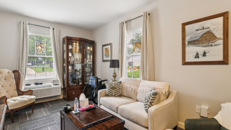 A cozy living space filled with warmth, featuring comfortable seating and natural light, inviting community.