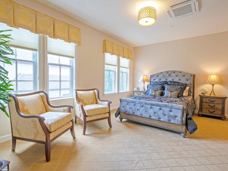 A serene bedroom featuring elegant furnishings and soft lighting, inviting warmth and community.