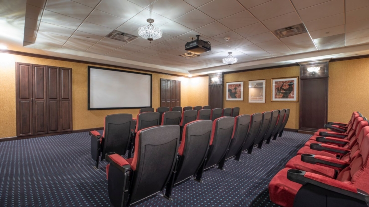 A welcoming theater space designed for community gatherings, featuring comfortable seating and a large screen.