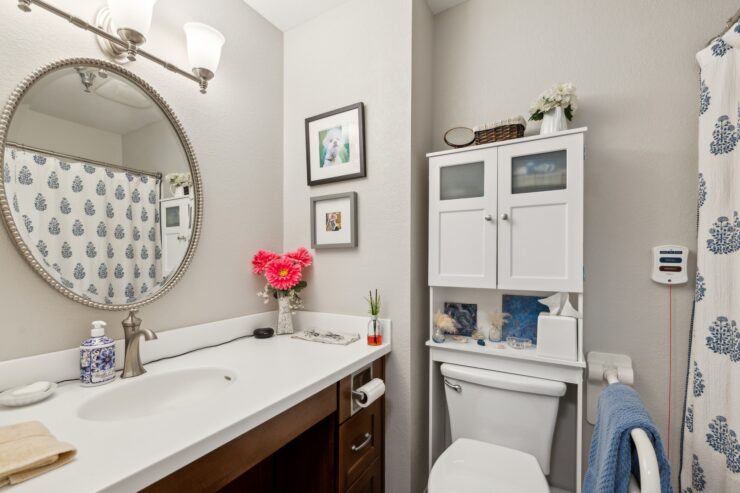 A bright, inviting bathroom featuring thoughtful decor and fresh flowers, exuding warmth and care.