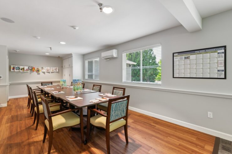 A welcoming activity room filled with natural light, fostering connection and creativity among residents.
