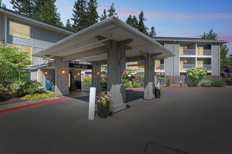 A welcoming entrance surrounded by lush greenery, inviting residents to enjoy a vibrant community.