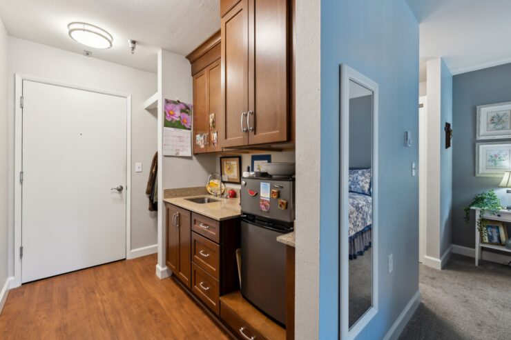 A welcoming entrance with warm wood tones and personal touches, fostering community and comfort.