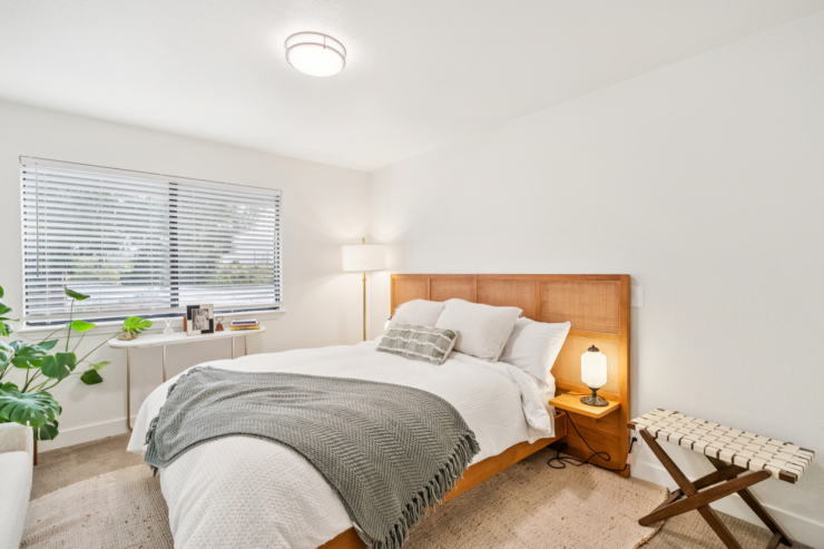 Bright and inviting, this serene bedroom offers a perfect retreat for relaxation and comfort.