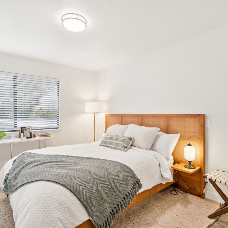 Bright and inviting, this serene bedroom offers a perfect retreat for relaxation and comfort.