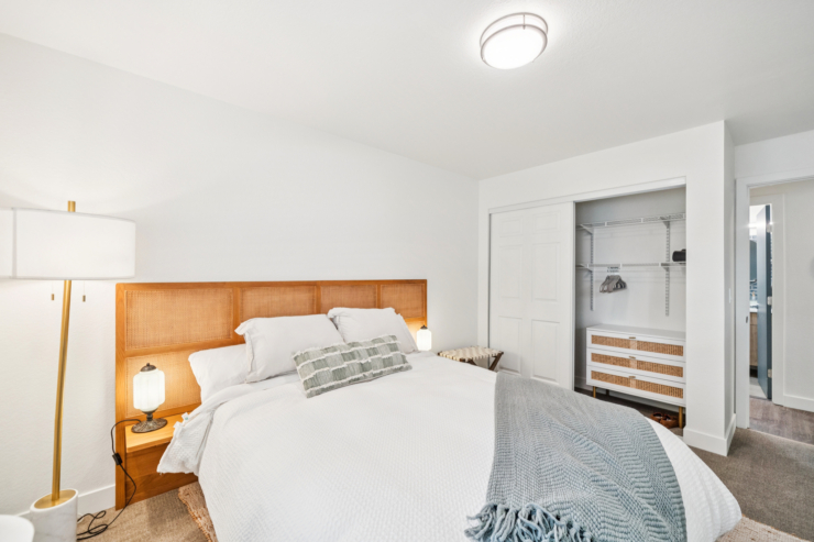 Bright, inviting bedroom with soft linens and warm lighting, fostering a sense of comfort and community.