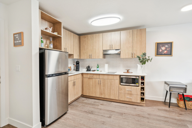A modern, welcoming kitchen that embodies community spirit, featuring natural wood tones and pleasant decor.