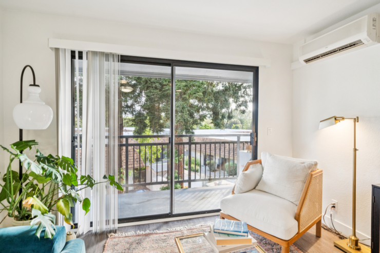 Bright and inviting space with comfortable seating, lush greenery, and a tranquil view of nature.