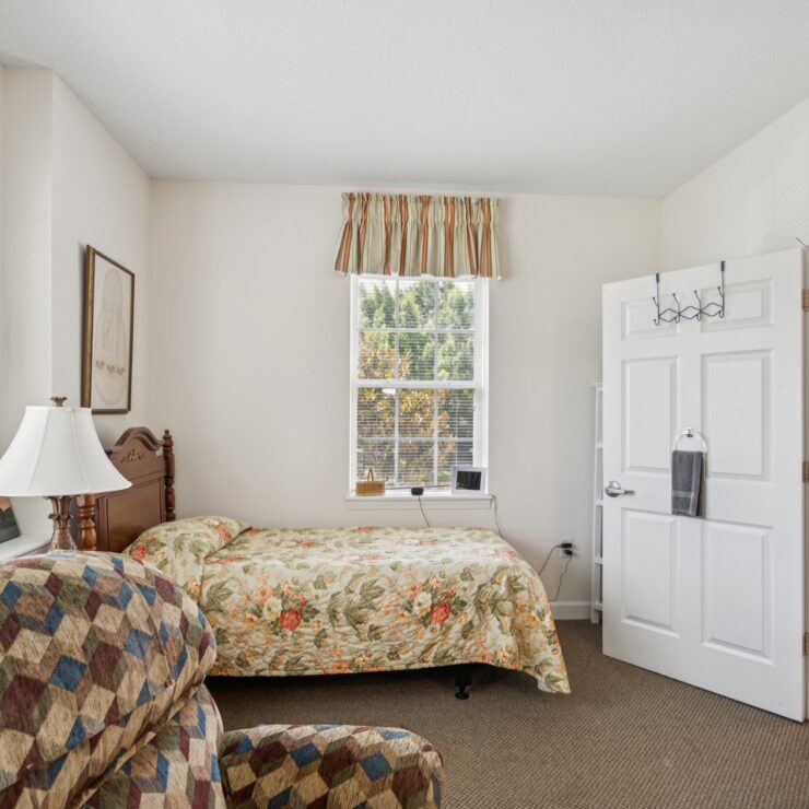 A bright, inviting room featuring floral decor, comfortable seating, and a warm, welcoming atmosphere.