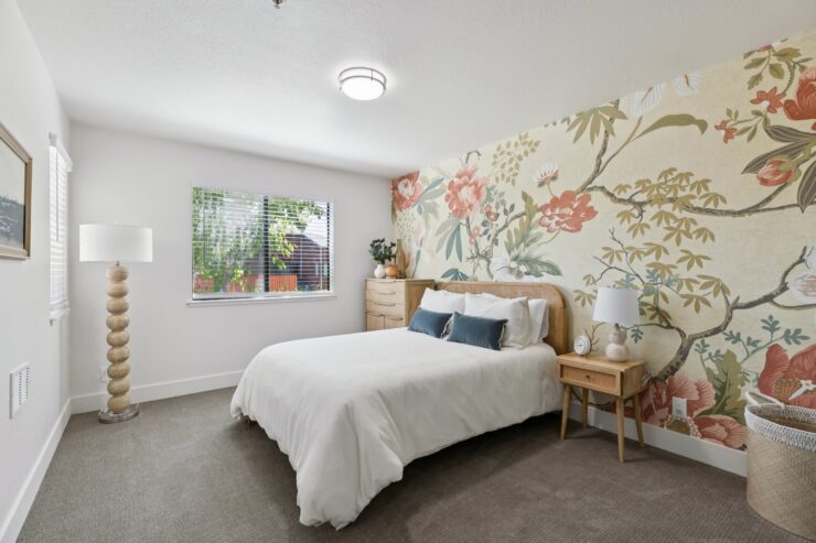 Bright and inviting, this serene bedroom features floral accents and natural light, fostering a sense of community and comfort.