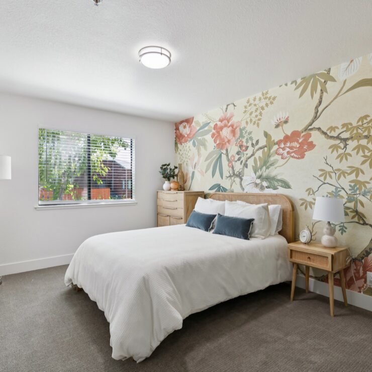 Bright and inviting, this serene bedroom features floral accents and natural light, fostering a sense of community and comfort.