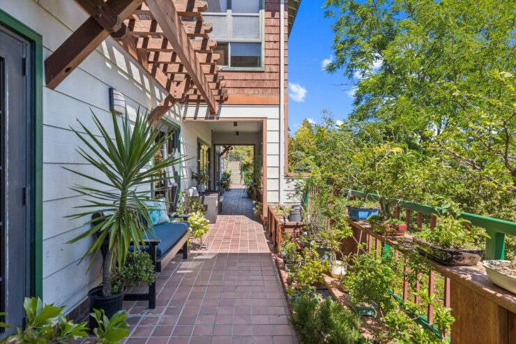 A welcoming pathway adorned with greenery invites relaxation and connection in a serene community setting.