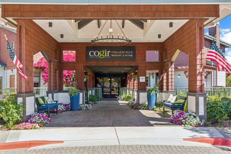 Welcoming entrance adorned with vibrant flowers, inviting seating, and a sense of community.