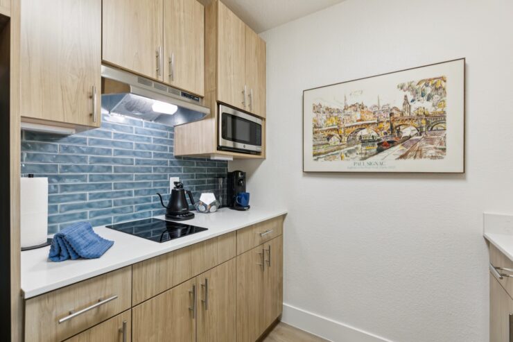 A bright, inviting kitchen features modern appliances and warm wood cabinetry, creating a welcoming atmosphere for community gatherings.