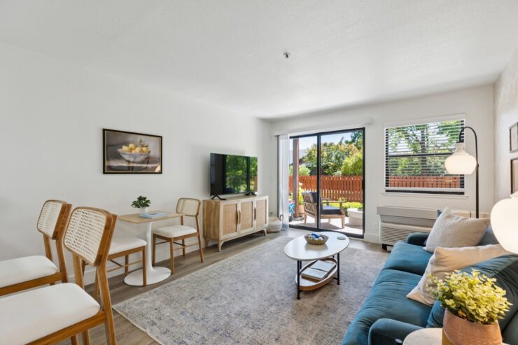 Bright and inviting, this living space fosters community and comfort with stylish furnishings and a view of nature.