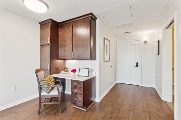 A welcoming space featuring a stylish desk, inviting chair, and warm decor, fostering community and comfort.