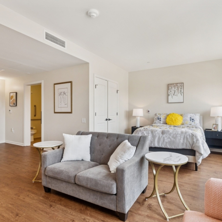A bright, welcoming room featuring soft furnishings and warm accents, inviting relaxation and community.