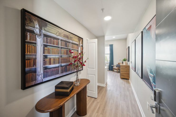 Bright and inviting hallway adorned with art, showcasing a sense of community and comfort.