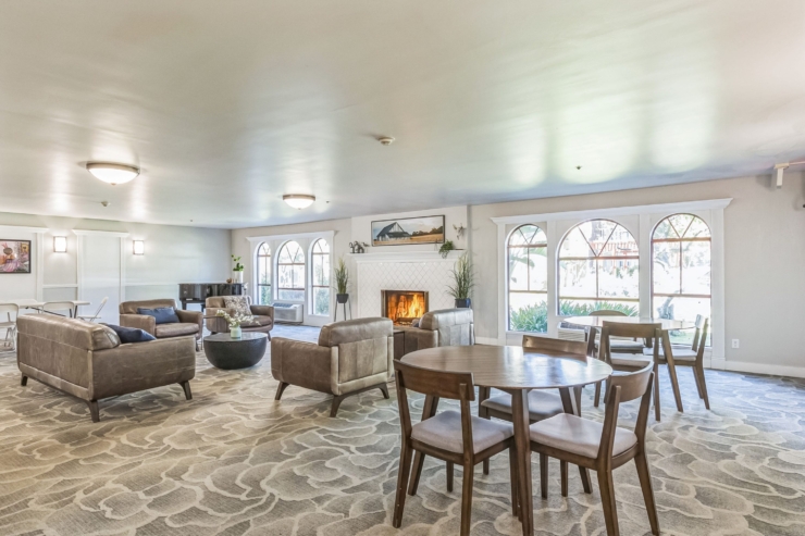 A warm gathering space featuring inviting furnishings, natural light, and a welcoming atmosphere.
