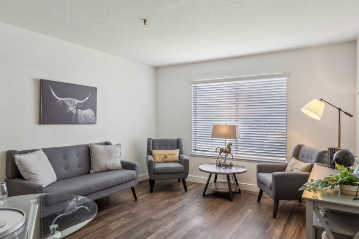 A welcoming living space features comfortable seating and natural light, perfect for community gatherings.