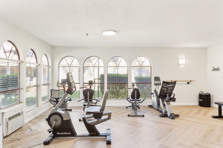 A bright fitness area invites residents to stay active, featuring modern equipment and natural light.