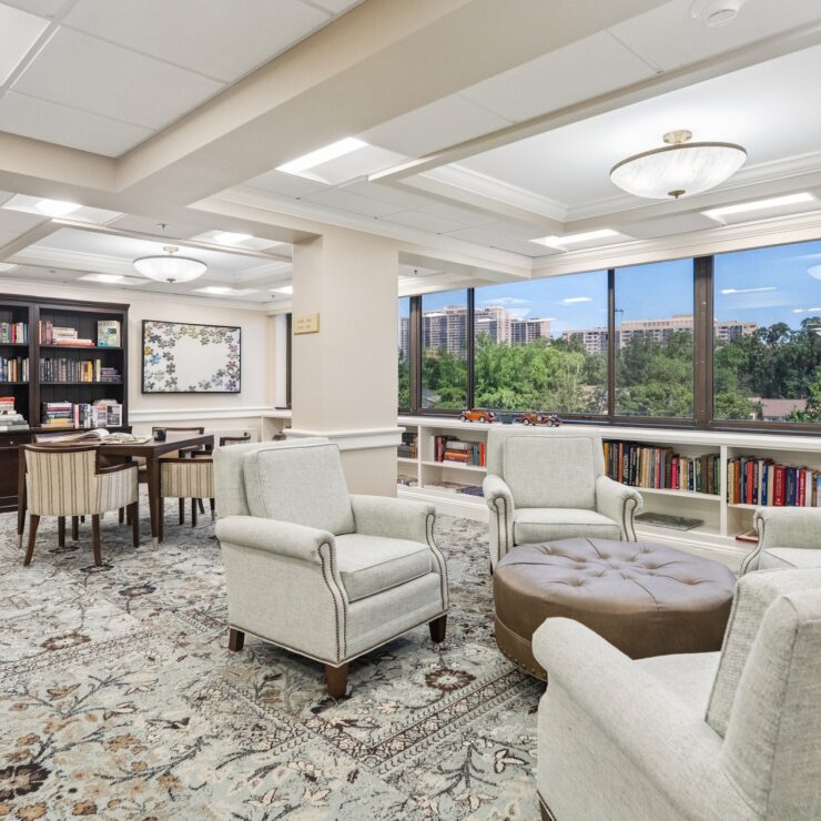 Bright and inviting space with comfortable seating, a warm atmosphere, and a view of lush greenery.