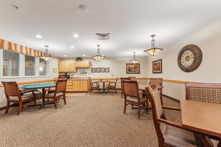 A cozy communal space featuring warm lighting, inviting furniture, and a friendly atmosphere for residents.