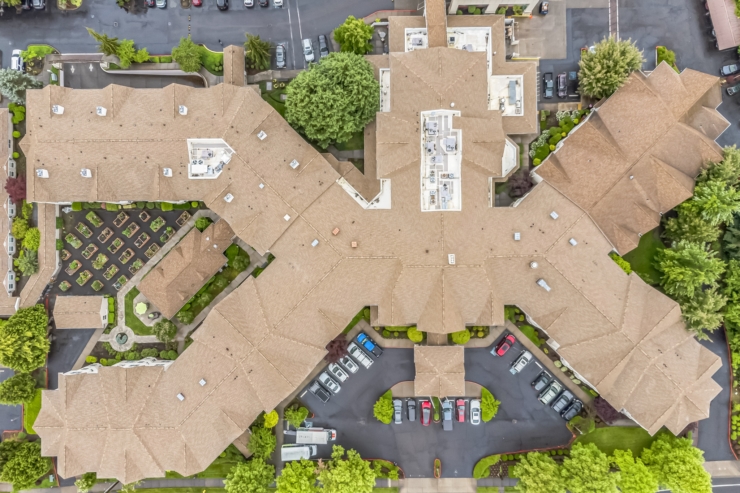 A welcoming community, surrounded by lush greenery and vibrant gardens, fosters connection and comfort.