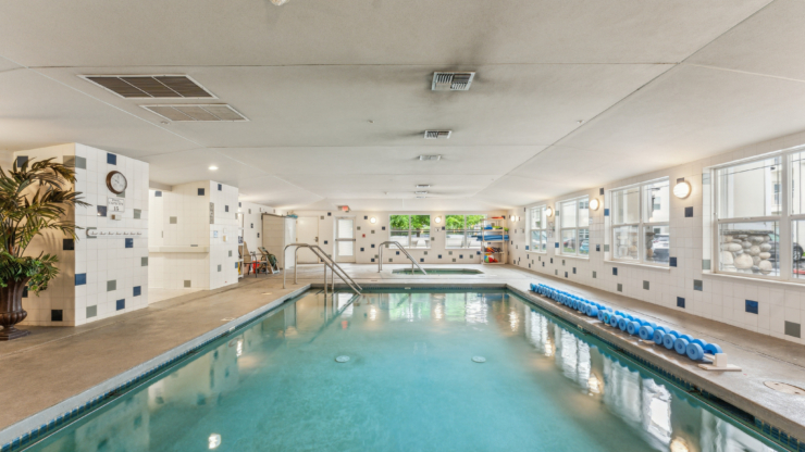A serene indoor pool area, inviting relaxation and community, perfect for wellness and social activities.