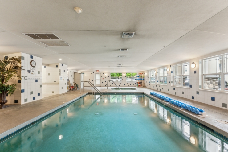 A serene indoor pool area, inviting relaxation and community, perfect for wellness and social activities.