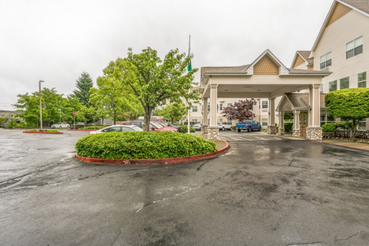 A welcoming entrance surrounded by lush greenery, inviting residents and visitors into a vibrant community.