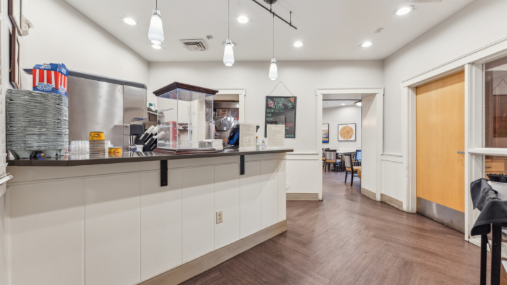 A welcoming dining area with a friendly service counter, inviting residents to connect and enjoy meals together.