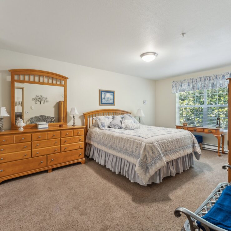 A bright, inviting bedroom with warm wood furnishings, creating a serene and welcoming atmosphere.
