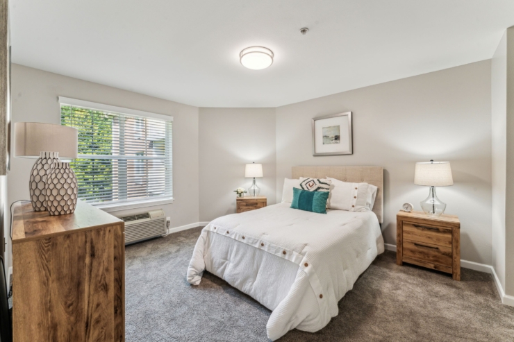 A bright, inviting bedroom featuring warm textures and natural light, perfect for restful moments.
