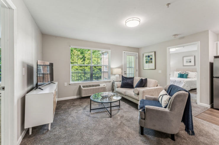A warm, inviting living space with natural light, featuring comfortable seating and a serene atmosphere.