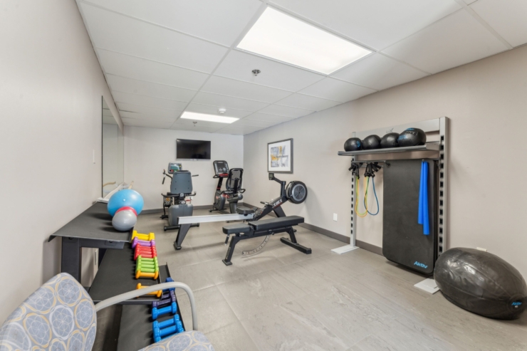 A bright fitness area equipped for engaging activities, fostering health and connection among residents.
